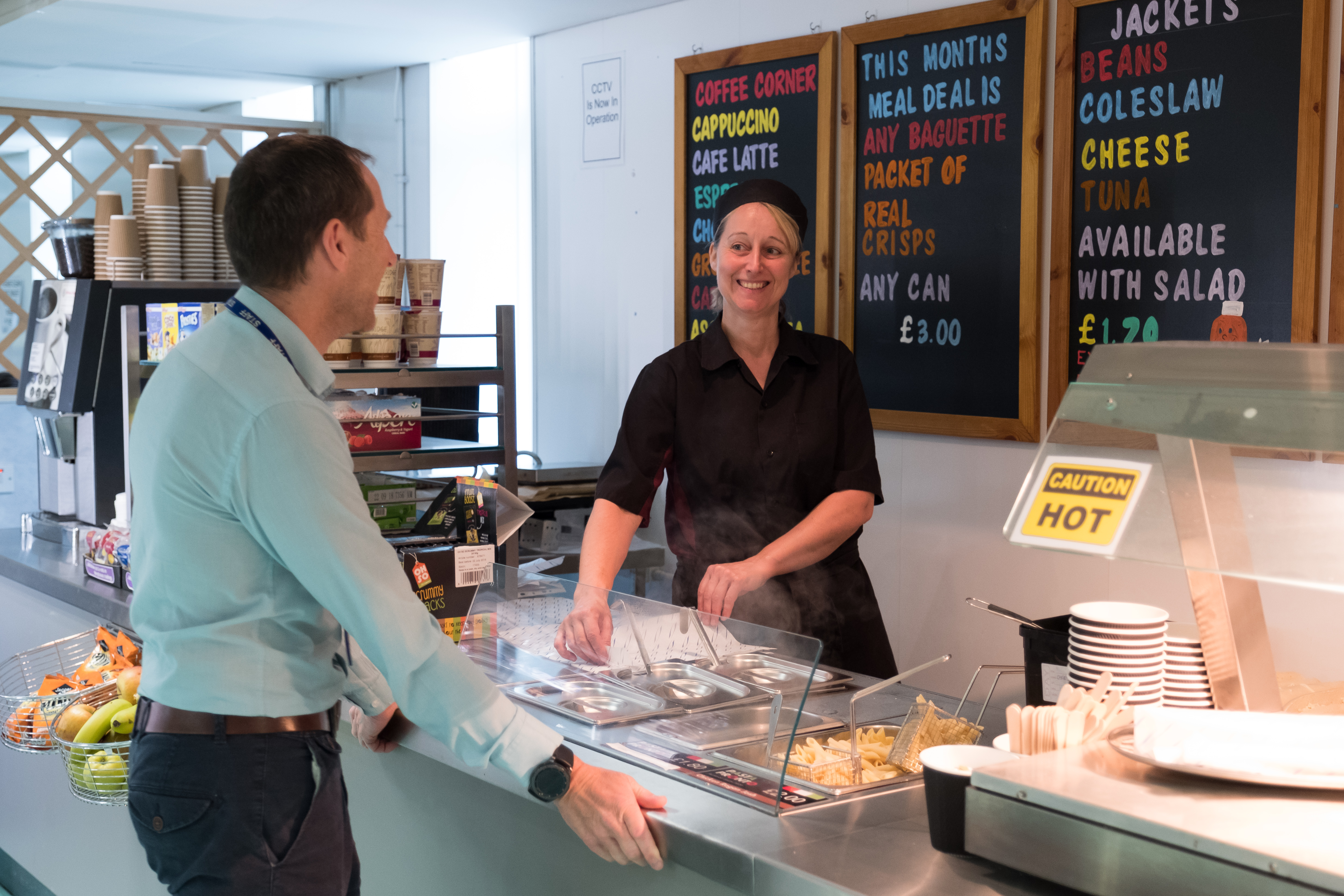Staff members pictured in the canteen smiling