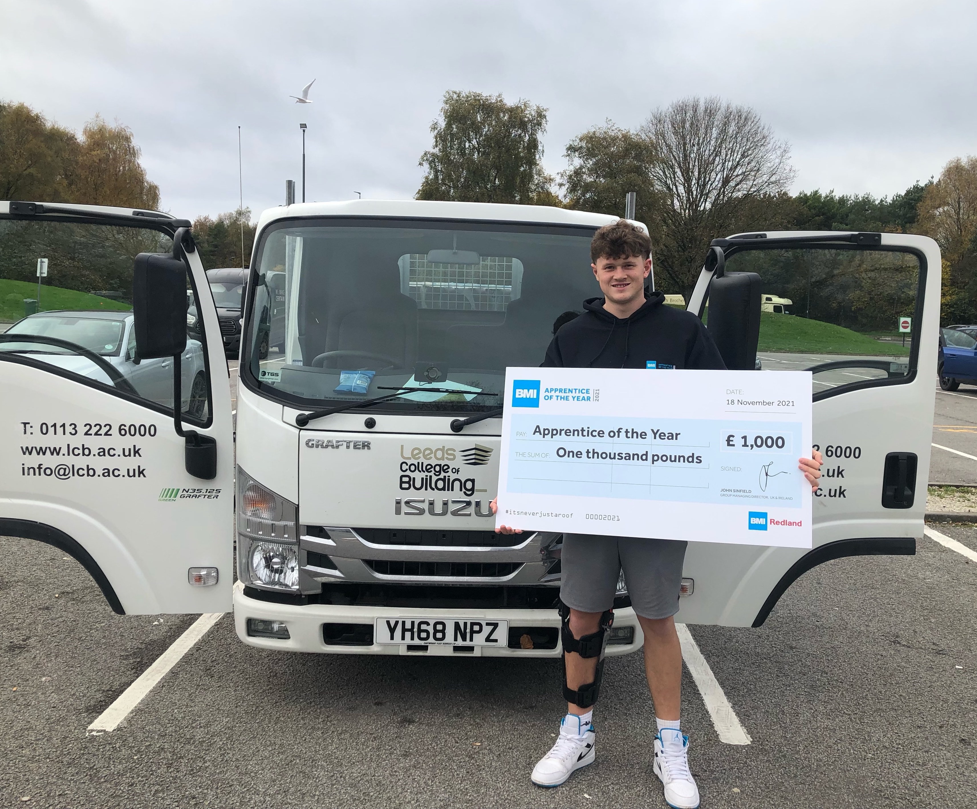 Leeds College of Building Apprentice, Jamie Scott, with his BMI Apprentice of the Year 2021 prize cheque.
