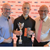 Newton with Skillbuild trophy and lecturers Mark Sims and Steve Edwards