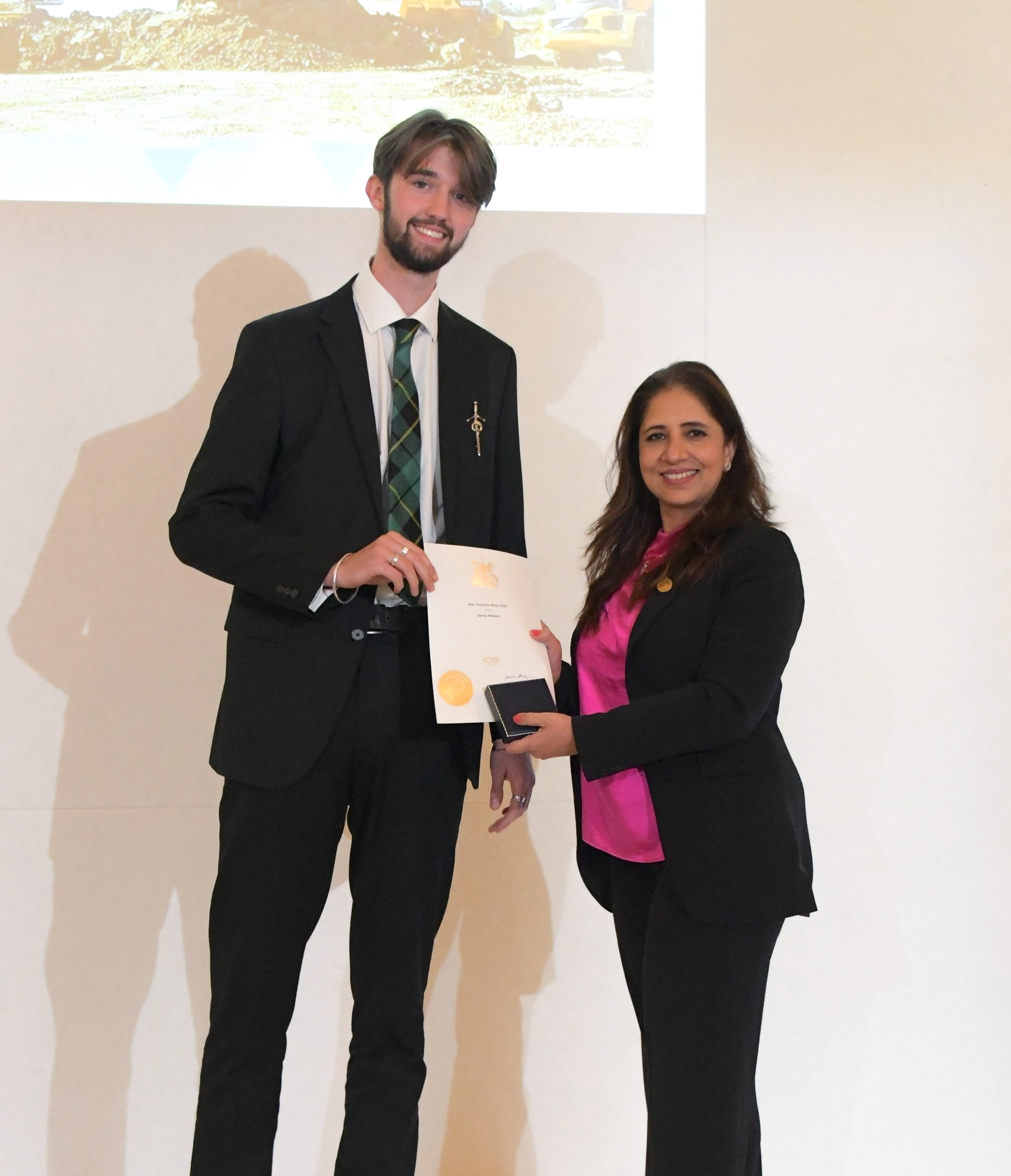 Image of Davey Wallace receiving his award and certificate