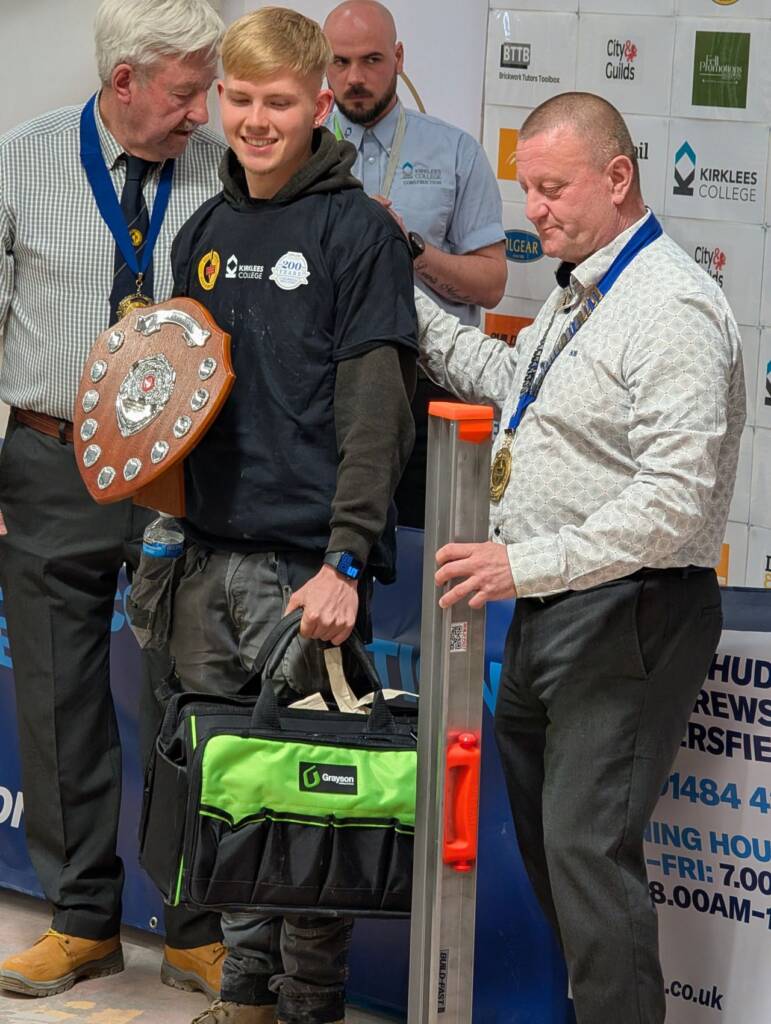 Image of Ellis Smith holding an award plaque.