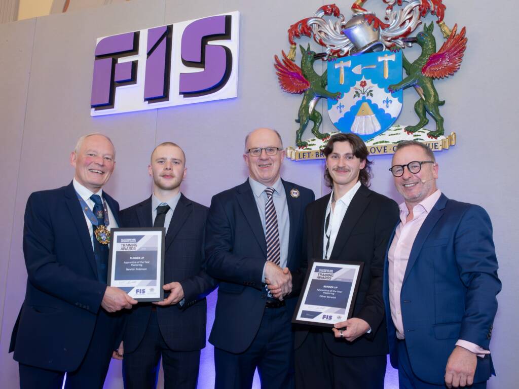 Image of Newton Robinson, named runner-up in the ‘Apprentice of the Year – Plastering’ award, standing along side the president and other members of the FIS.