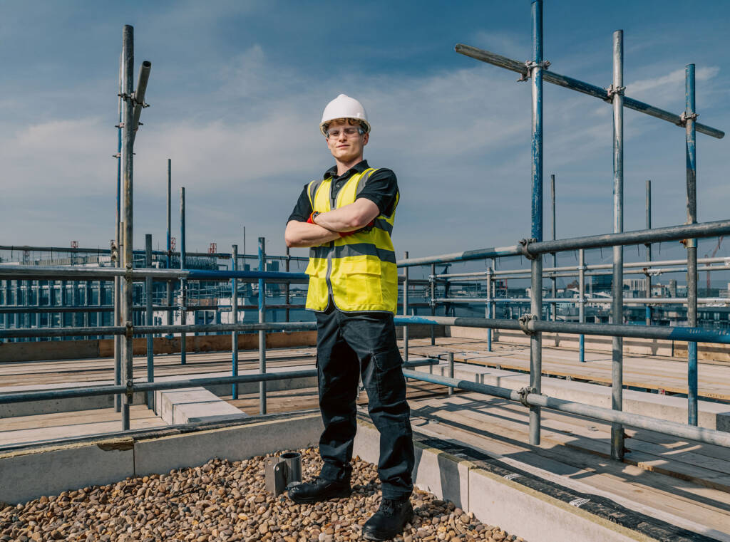 This photo depicts a LCB student in full safety gear standing in a construction site.