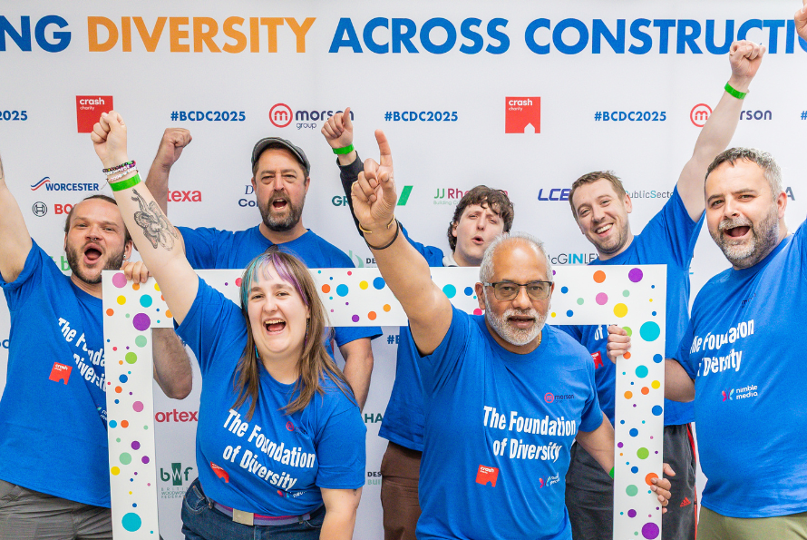 LCB team 'The Foundation of Diversity' posing for a group photo with their arms in the air