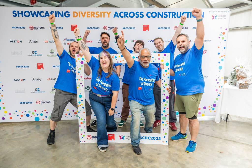 LCB team 'The Foundation of Diversity' posing for a group photo with their arms in the air