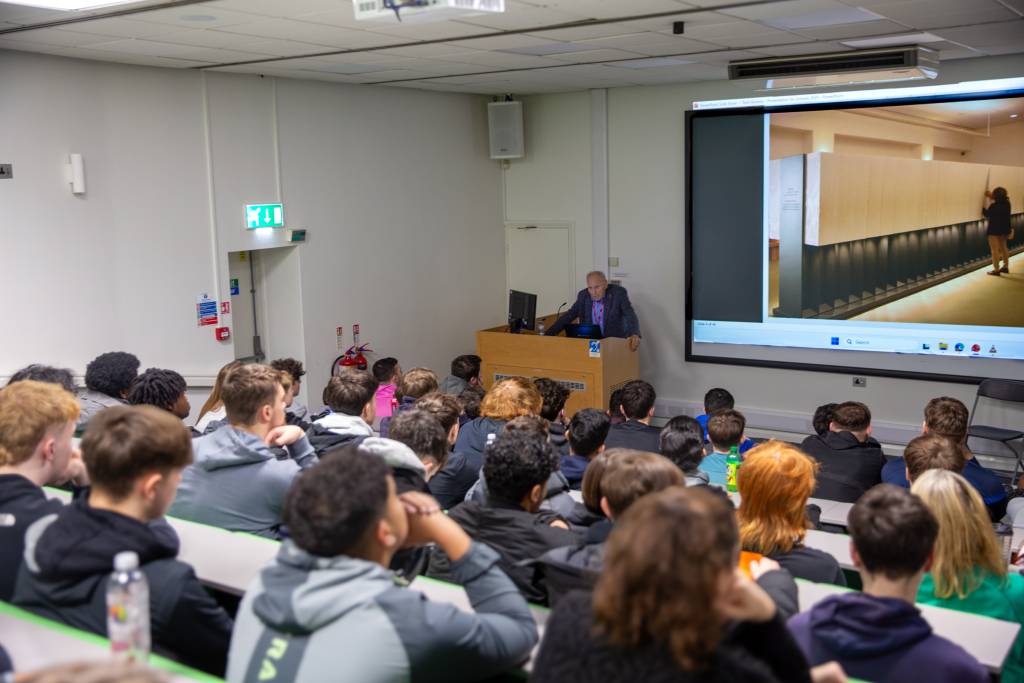 Holocaust survivor Tomi Komoly BEM addressing LCB's North Street Lecture Theatre 