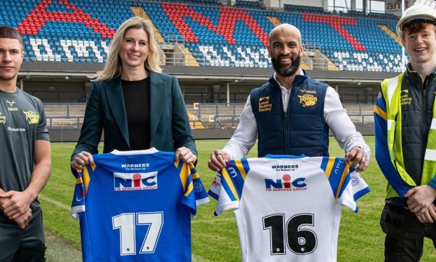 (L-R) Wade White, Leeds Rhino Academy player and apprentice; Emma Grant, Head of Trade Engagement, Checkatrade; Jamie Jones-Buchanan MBE, CEO, Leeds Rhinos; Finn Beaumont, apprentice at Leeds Rhinos stadium and attends Leeds College of Building.