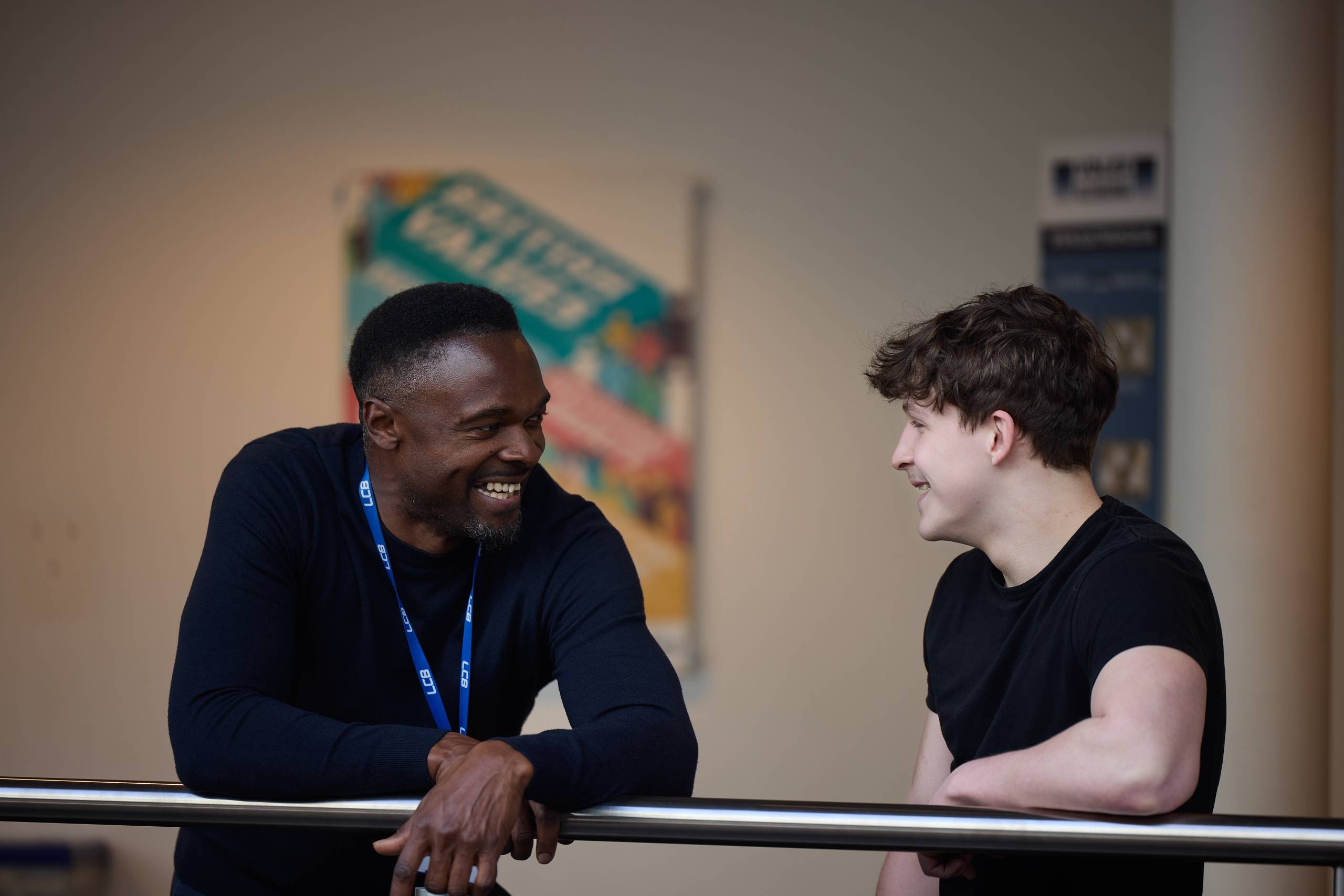 This image depicts a student talking to a member of college staff at the South Bank campus