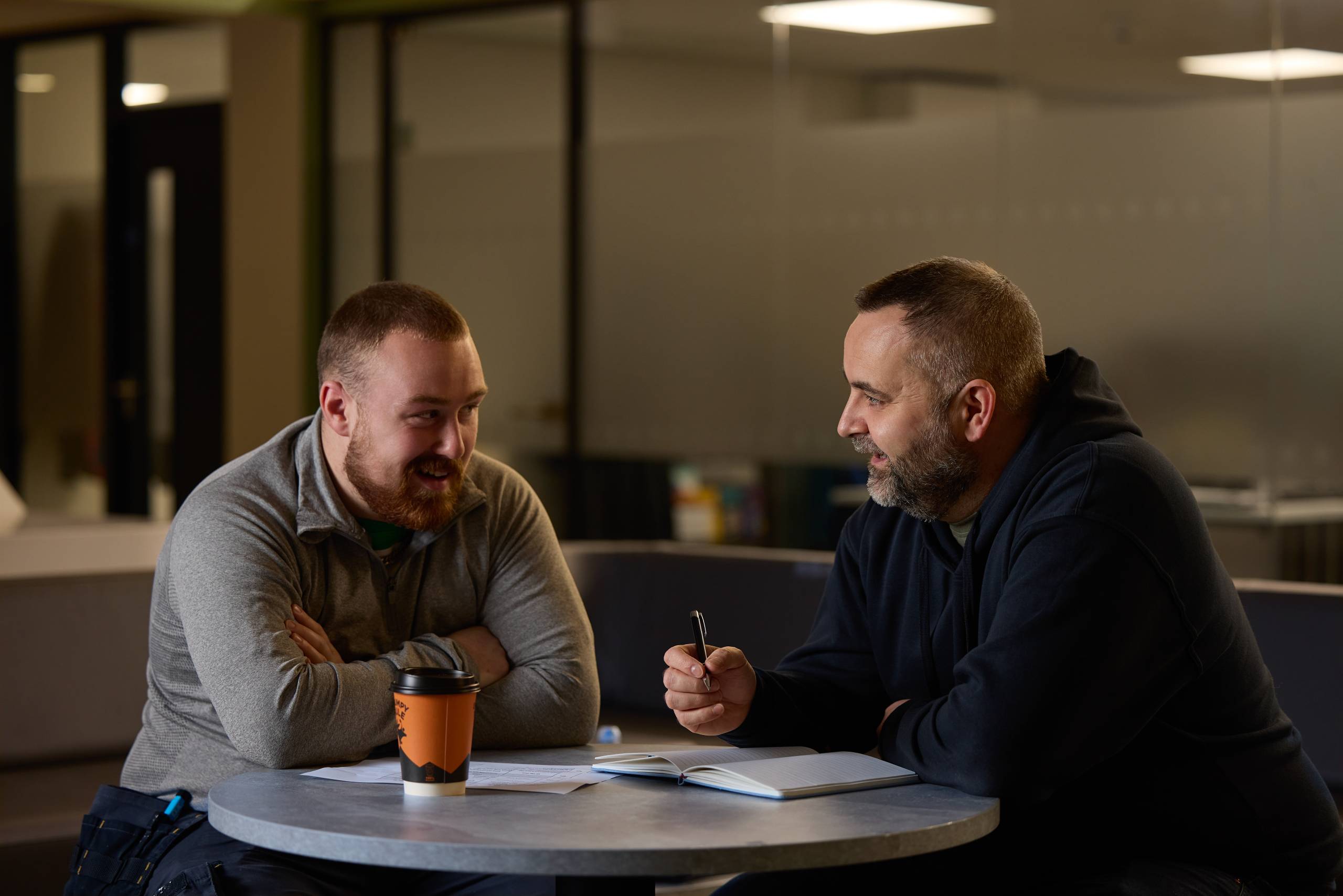 This image depicts a student talking to a member of college staff at the North Street campus