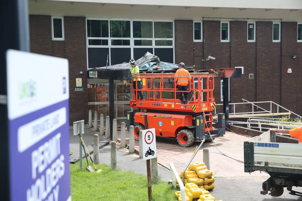 Builders demolishing North Street building canopy.