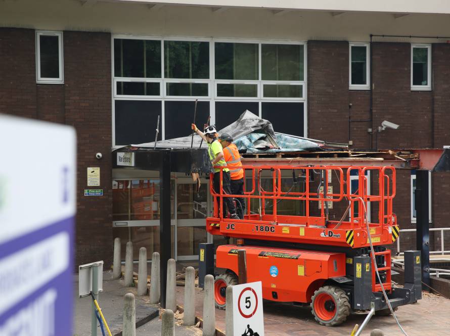 Builders demolishing North Street building canopy.