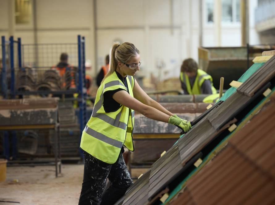 A female LCB roofing student in the roofing workshop.