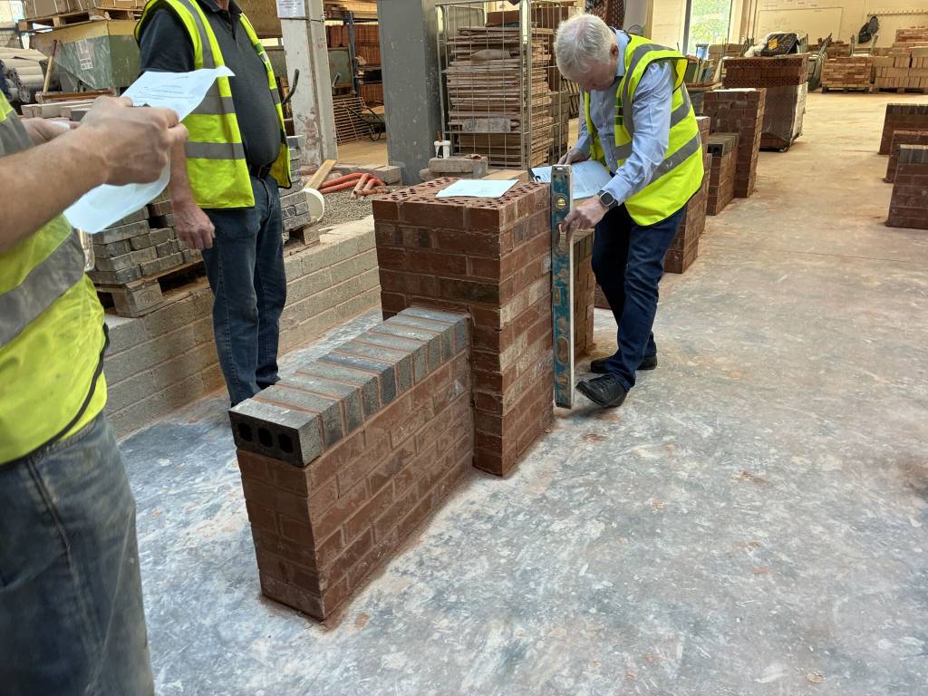Judge assessing work by LCB students during competition.