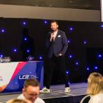 This photo depicts host Rich Williams giving an introductory speech at the awards.