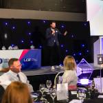 This photo depicts host Rich Williams giving an introductory speech at the awards.