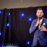 This photo depicts host Rich Williams giving an introductory speech at the awards.