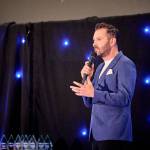 This photo depicts host Rich Williams giving an introductory speech at the awards.