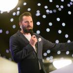 This photo depicts host Rich Williams giving an introductory speech at the awards.