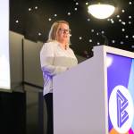 This photo depicts Leeds College of Buildings CEO & Principal, Nikki Davis, giving an introductory speech at the awards.