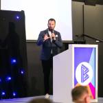 This photo depicts host Rich Williams giving an introductory speech at the awards.