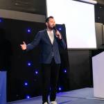 This photo depicts host Rich Williams giving an introductory speech at the awards.