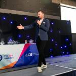This photo depicts host Rich Williams giving an introductory speech at the awards.