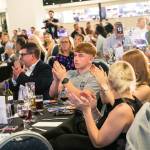 This photo depicts multiple guests at the awards sitting at their tables.