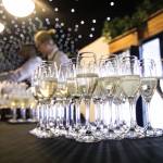 This photo depicts several glasses of drinks, intended to be handed out to guests as they enter the venue.