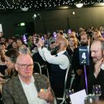 This photo depicts multiple guests at the awards sitting at their tables.