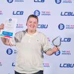 This photo depicts a student with their award against the LCBU photo wall.