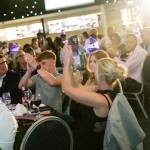 This photo depicts multiple guests at the awards sitting at their tables.
