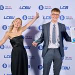 This photo depicts a student with their award against the LCBU photo wall.