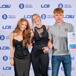 This photo depicts a student with their award against the LCBU photo wall.