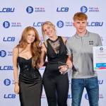 This photo depicts a student with their award against the LCBU photo wall.
