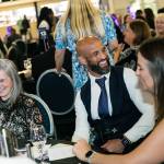 This photo depicts multiple guests at the awards sitting at their tables.