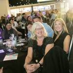 This photo depicts multiple guests at the awards sitting at their tables.