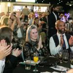 This photo depicts multiple guests at the awards sitting at their tables.