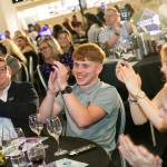 This photo depicts multiple guests at the awards sitting at their tables.