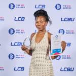 This photo depicts a student with their award against the LCBU photo wall.