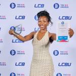 This photo depicts a student with their award against the LCBU photo wall.