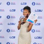 This photo depicts a student with their award against the LCBU photo wall.