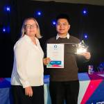 This photo depicts a student receiving the principles award from Nikki Davis.