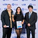 This photo depicts a student with their award against the LCBU photo wall.