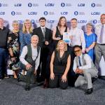 This photo depicts a student with their award against the LCBU photo wall.