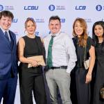 This photo depicts a staff team photo against the LCBU photo wall.