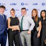 This photo depicts a staff team photo against the LCBU photo wall.