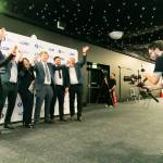 This photo depicts a student with their award against the LCBU photo wall.