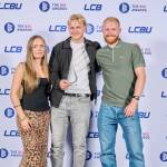 This photo depicts a student with their award against the LCBU photo wall.