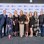 This photo depicts a staff team photo against the LCBU photo wall.
