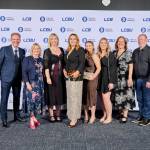 This photo depicts a staff team photo against the LCBU photo wall.